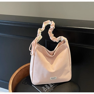 Detailed macro of pink tote bag with ruched cloud handle and elegant side drawstrings