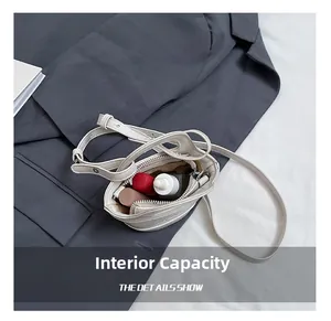 Macro detail showing internal capacity of the mini white leather crossbody bag