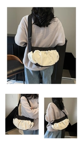 Detailed side and back view of a contrast black and white dumpling crossbody bag
