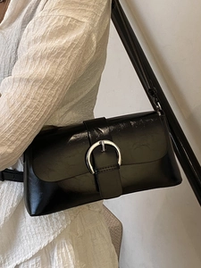 Minimalist black oil wax leather shoulder bag with a large silver round buckle detail