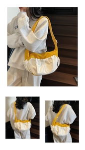 Detail of a contrast color canvas bag with drawstring front pocket and wide strap