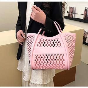 Detailed side view of pink hollowed-out tote bag with elegant geometric diamond patterns