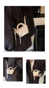 Detail view of cream mini handbag featuring pearl accents, lace bow, and lychee texture