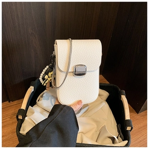 Detail of white lychee pattern phone bag with silver buckle and astronaut charm
