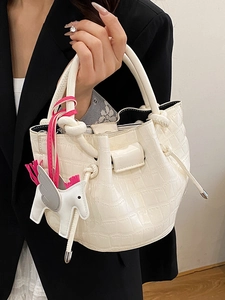 Chic cream-white bucket bag with stone pattern texture and decorative horse pendant