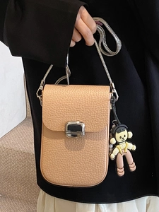 Minimalist apricot lychee texture crossbody phone bag with silver buckle and doll charm