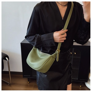 Detailed texture of green lychee leather hobo bag with adjustable silver buckle strap