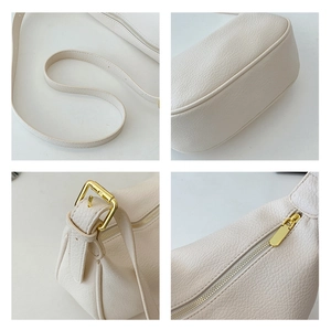 Detailed view of white litchi pattern texture with adjustable strap and golden zipper
