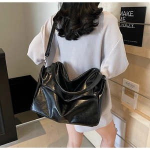 Detailed back view of a spacious black oiled leather tote bag with stylish slouchy design