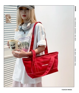 Detail of red canvas tote bag with Lovey Summer print and visible stitching craft