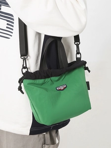 Sporty green and black nylon crossbody bag with adjustable wide shoulder strap