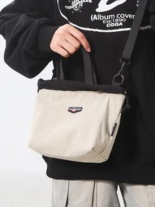 Casual mini drawstring crossbody bag in beige and black with adjustable nylon shoulder strap
