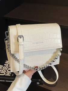 Elegant white crocodile embossed crossbody bag with pearl chain detail and silver hardware
