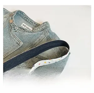 Detail of light blue denim tote with a comfortable polka dot pattern inner shoulder strap