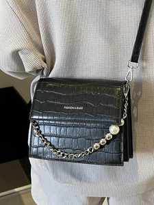 Elegant black faux leather crossbody bag with stone pattern and pearl chain detail