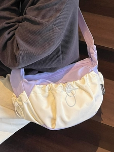 Chic two-tone dumpling bag in purple and beige with pleated texture and crossbody strap