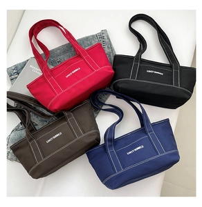 Flat lay of canvas tote bags in red, black, brown and blue with Lovey Summer text