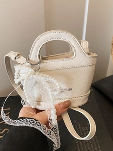 Mini white textured leather handbag with pearl lace charm and crossbody strap
