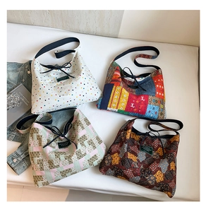 Detailed flat lay of four colorful canvas tote bags with ethnic patterns and tie-top closure