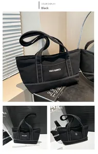Detail of black canvas tote bag with contrast stitching and LOVEY SUMMER print