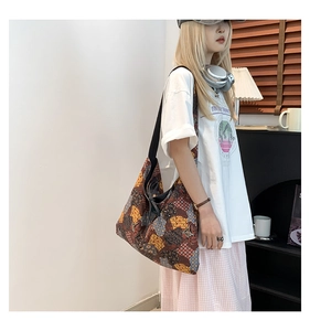 Detail view of ethnic patchwork tote bag with bohemian print and wide black strap