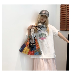 Lifestyle view of large patchwork tote bag with drawstring closure and colorful patterns
