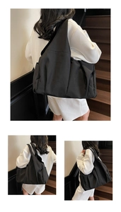 Detail view of large black nylon tote bag showing side pocket and spacious design