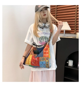 Close-up of patchwork canvas tote bag with bohemian colorful patterns and text label