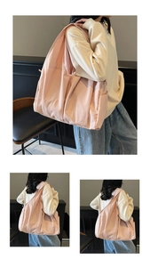 Detail view of pink canvas tote bag showing side pockets and soft pleated fabric