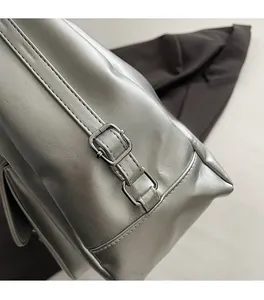 Detailed close-up of polished silver hardware and fine stitching on the stylish tote bag