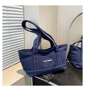 Detail of navy canvas tote bag with Lovey Summer print and white contrast stitching
