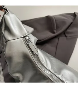 Detail of high-quality smooth silver metal zipper and lychee pattern leather on tote bag