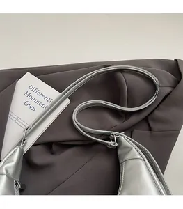 Detail of silver faux leather tote bag with metallic texture and sleek metal zipper