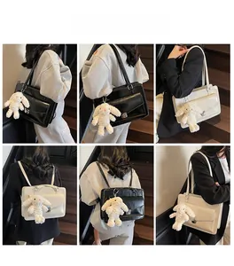 Detailed views of versatile black and white PU leather school bags with plush rabbit charm