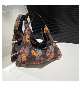 Detail view of ethnic patchwork tote bag with bohemian patterns and drawstring closure