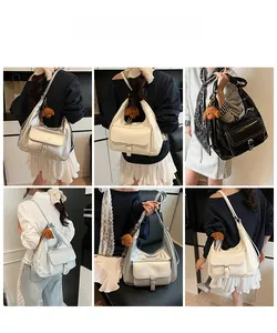 Detailed shots of large tote bag in black, white, and silver with plush puppy charm