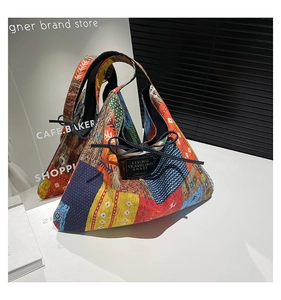 Close-up of bohemian patchwork tote with geometric patterns and decorative bow detail