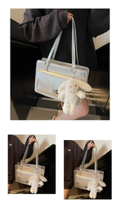 Detailed macro view of a silver rectangular briefcase featuring a cute plush bunny charm
