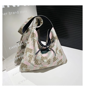 Close-up of color-block patchwork tote bag with leopard print and floral fabric detail