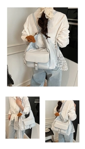 Macro view of light grey tote bag showing smooth faux leather texture and buckle detail