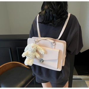 Detail of JK style light pink PU leather backpack featuring cute bunny plush pendant detail