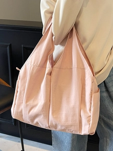 Minimalist light pink large capacity tote bag shown from side angle for casual commute