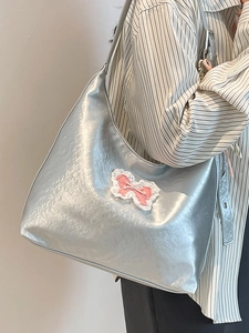 Silver metallic hobo tote bag featuring a lace bow with pearls and pleated texture