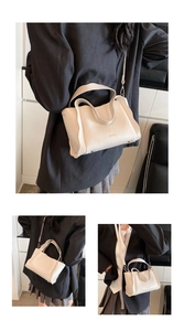 Detail view of cream lychee texture leather bucket bag with embossed logo and metal feet