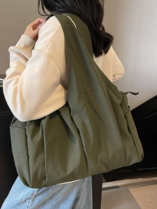 Minimalist large army green canvas tote bag for women showing crossbody style on a model
