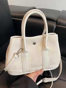 Chic pleated bucket bag in creamy white leather with vertical stripes and silver buckle