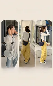 Three minimalist crossbody bags in grey, black and navy nylon with adjustable straps