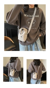 Detail of beige sporty drawstring crossbody bag with round logo and nylon texture