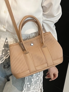 Chic beige pleated bucket bag with dual handles and silver buckle detail for daily use