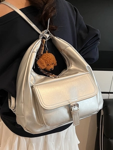 Silver metallic oversized hobo tote bag with front buckle pocket and plush dog charm